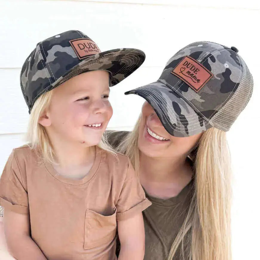 Mom and son wearing matching Camo hats, perfect for every boy mom hat enthusiast.