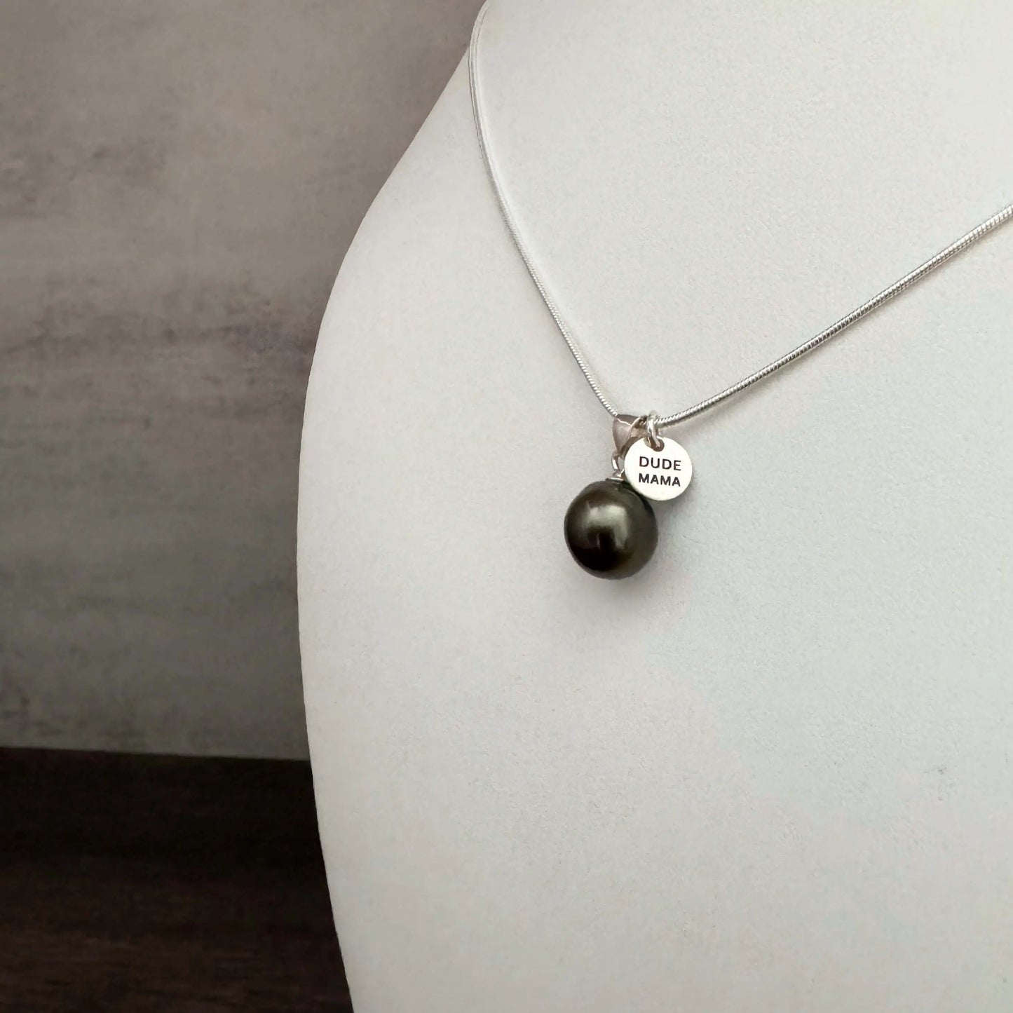 Engraved Dude Mama Tahitian Pearl Necklace featuring a medium-dark pearl and pendant on a silver chain.