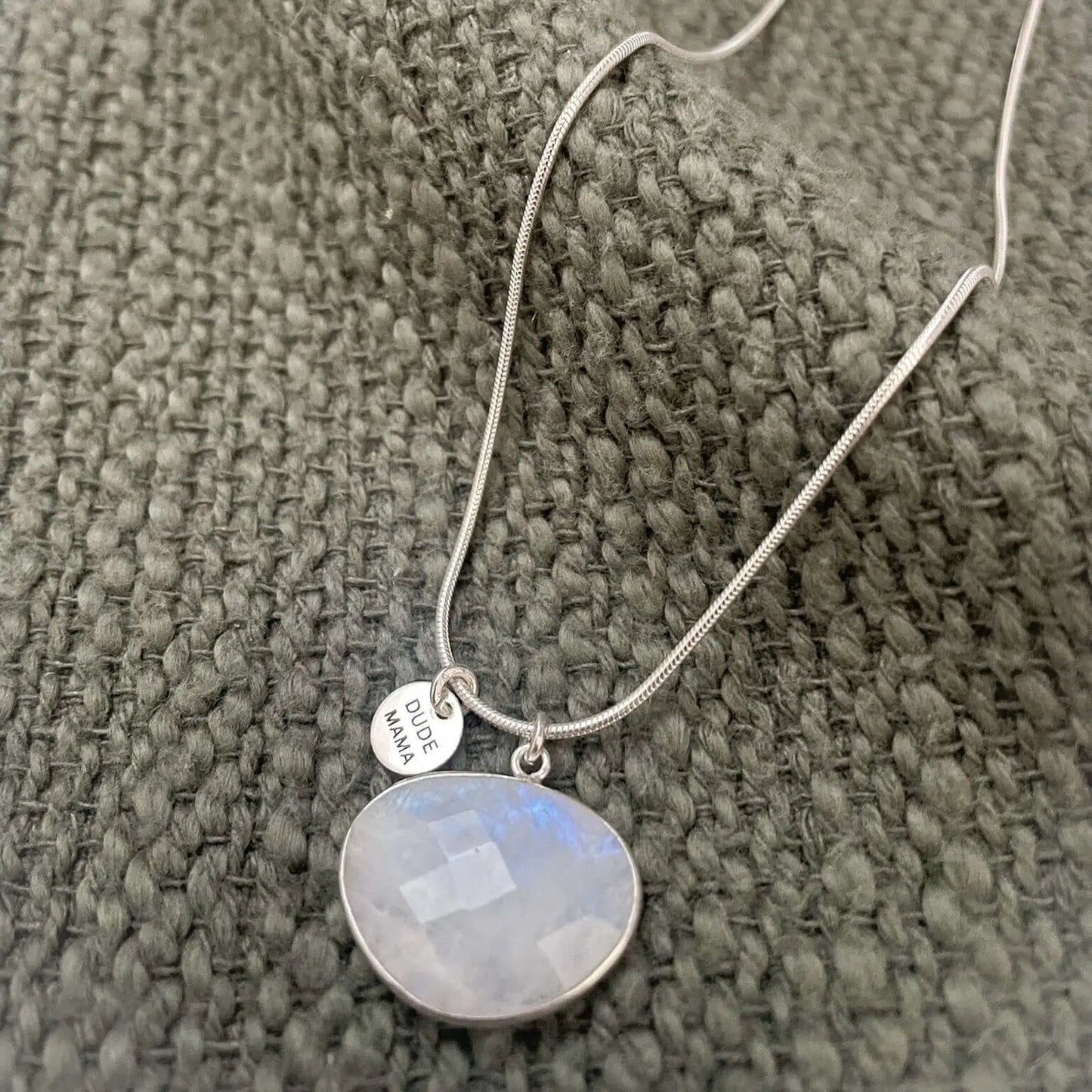 Engraved Dude Mama Moonstone Necklace showcasing a luminous moonstone pendant on a silver chain.