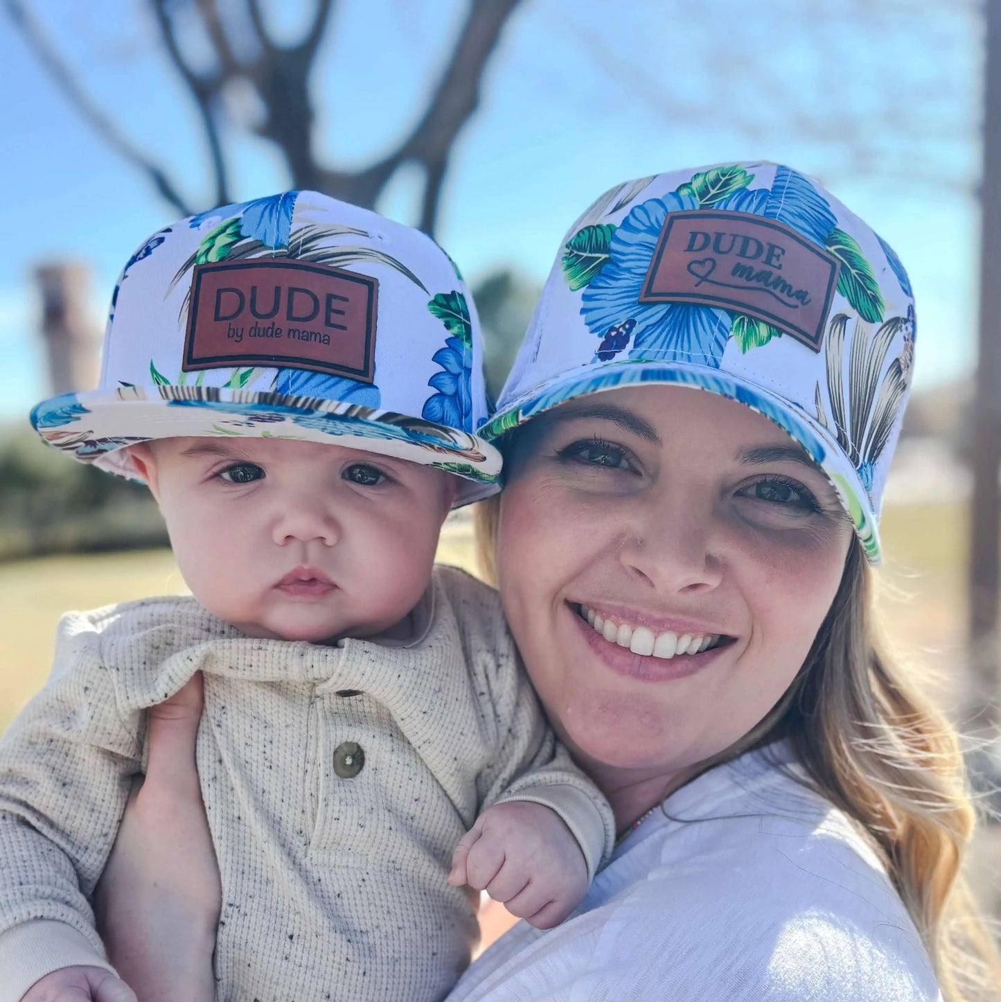 Matching hats: mom and baby wearing blue Hawaiian patch matching hats outdoors, showcasing connection and style. Blue Hawaiian matching hats - boy mom hat and dude hat