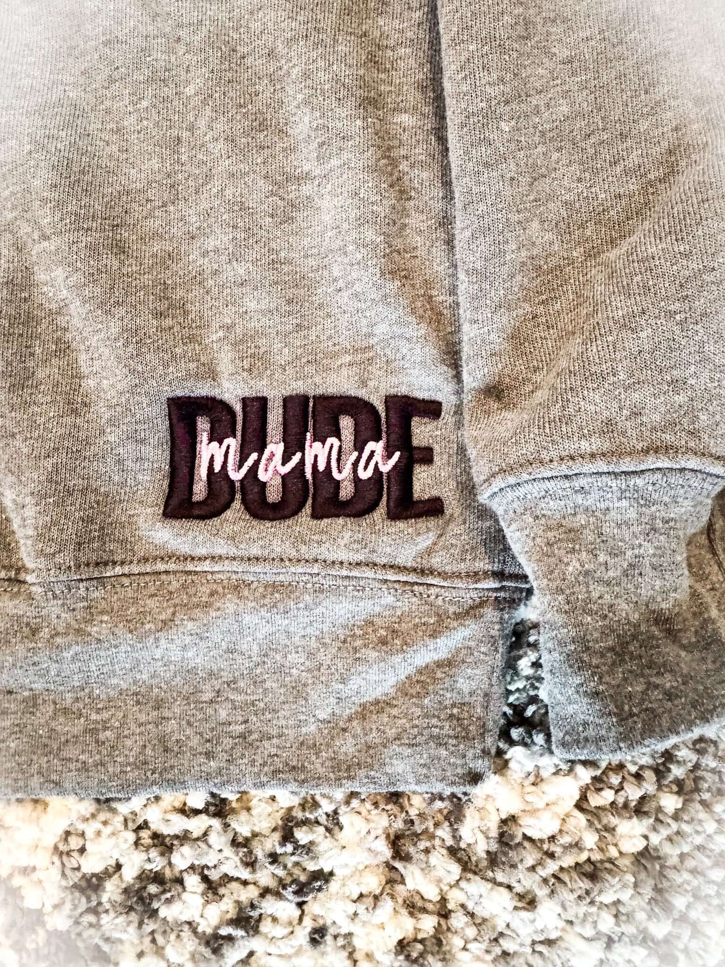 Dude Mama Boy Mom Sweatshirt showing the word 'Dude' and 'mama' in stylish embroidery on gray fabric.