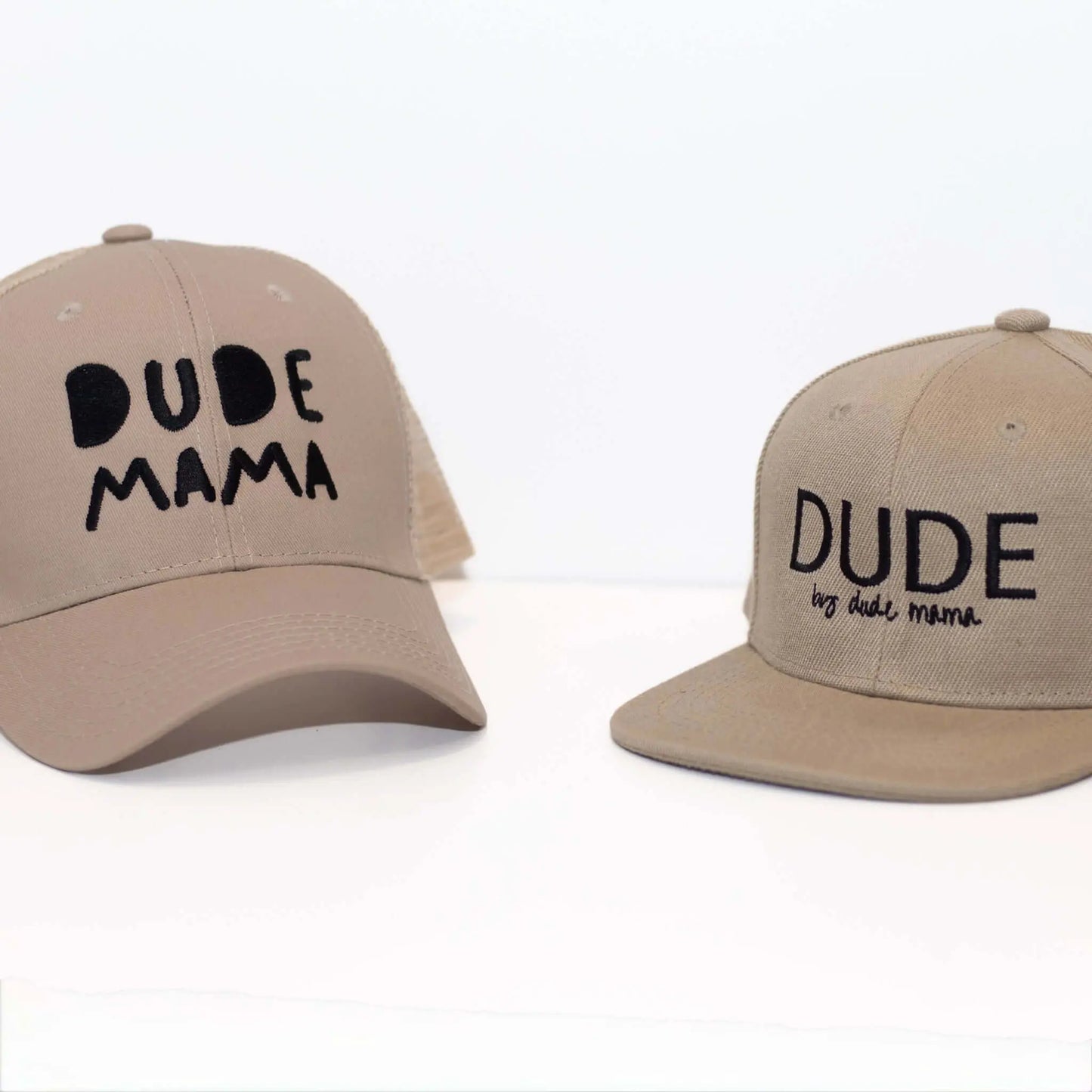 Tan Dude Mama Hat and Dude cap displayed together on a clean background, showcasing stylish designs for boy moms. Boy mom hat and Dude hat