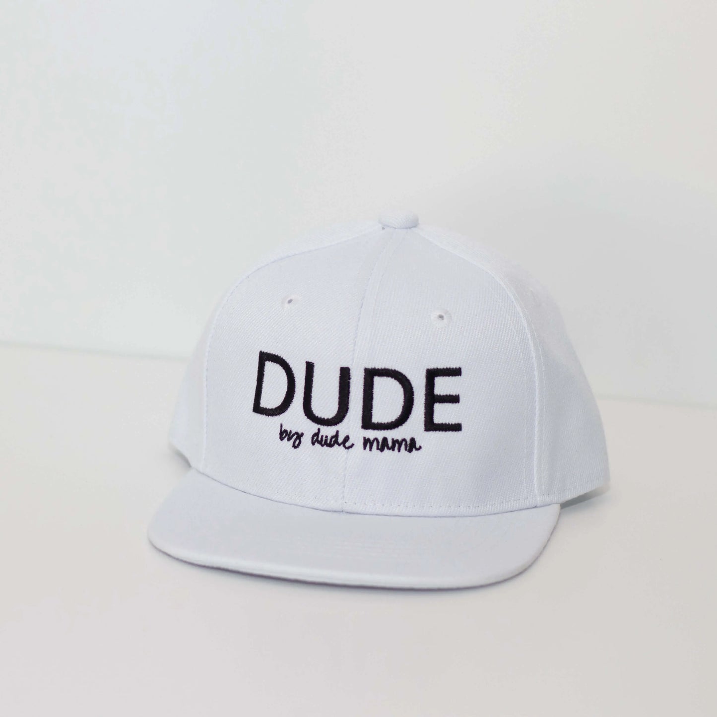 Classic white boy hat with black 'DUDE' embroidery, perfect for stylish boys looking to boost their confidence.