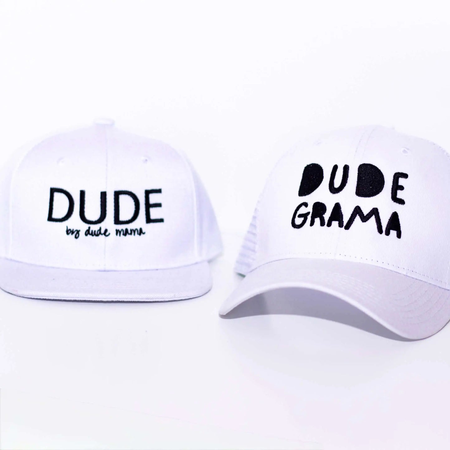 Two white hats featuring the words 'Dude' and 'Dude Grama', showcasing the unique grandma hat design for special bond.