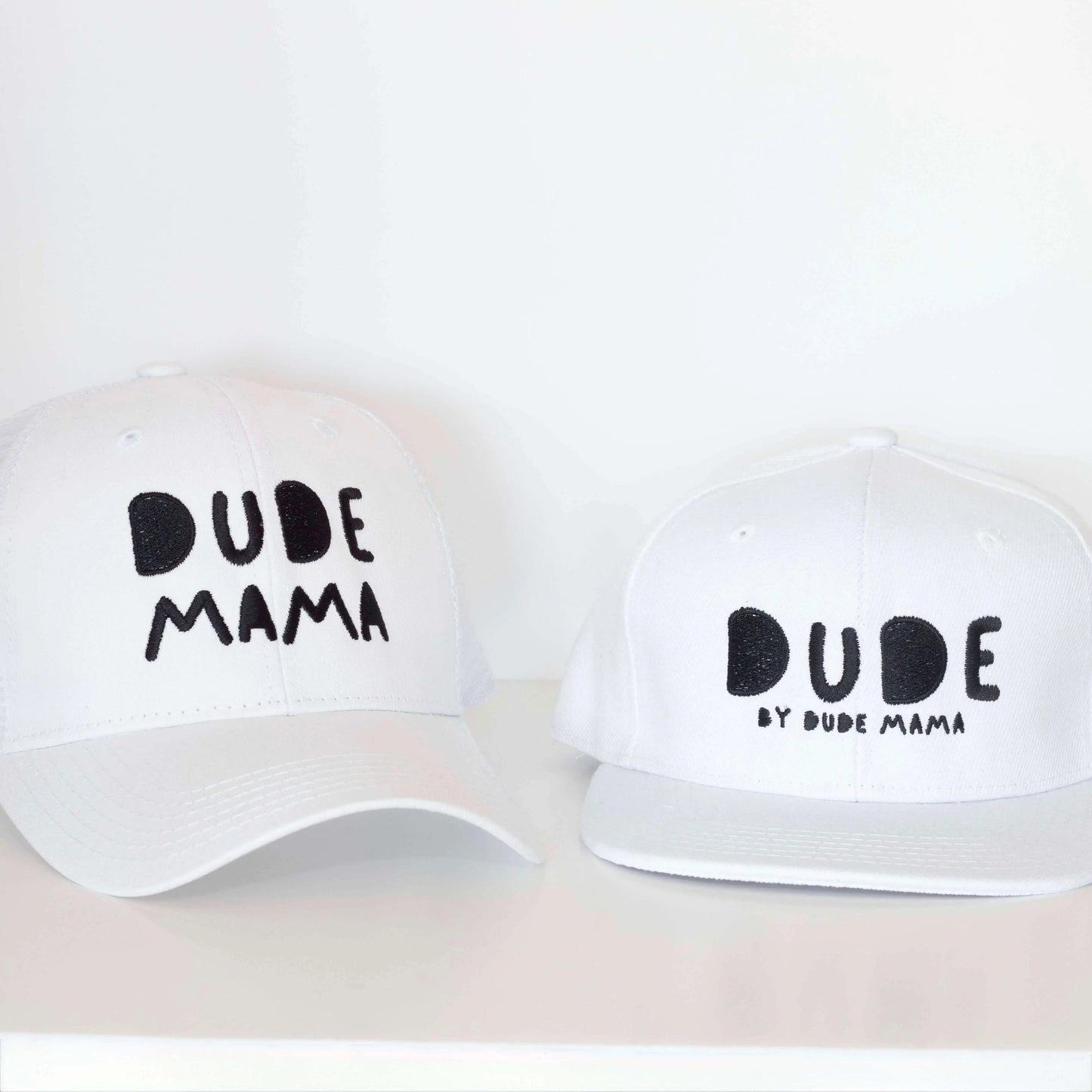 White boy hat featuring stylish designs with the words 'DUDE' and 'DUDE MAMA'.