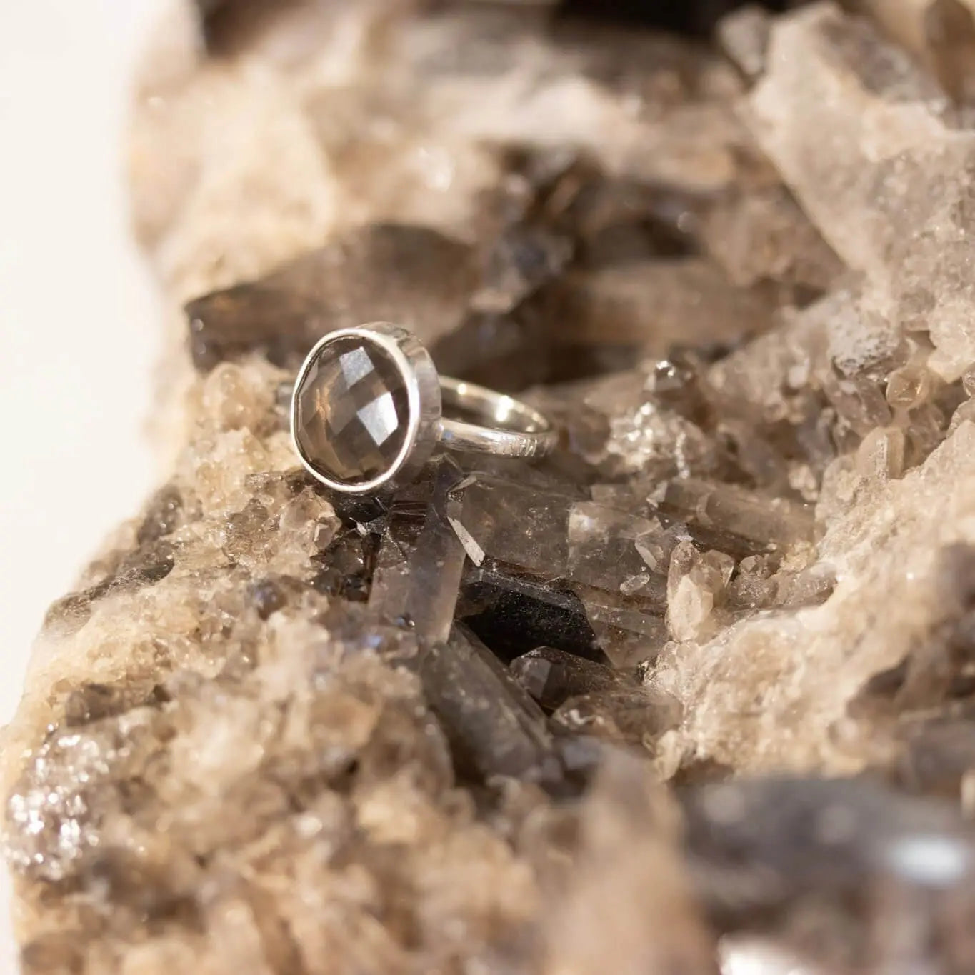 Engraved Dude Mama smoky quartz ring for baby shower gift on natural mineral surface.