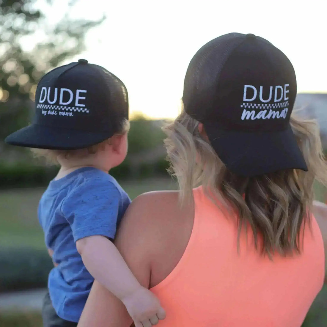 Mom and son wearing matching black and checkered hats. 