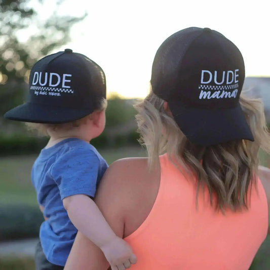 Mom and son wearing matching black and checkered hats. 