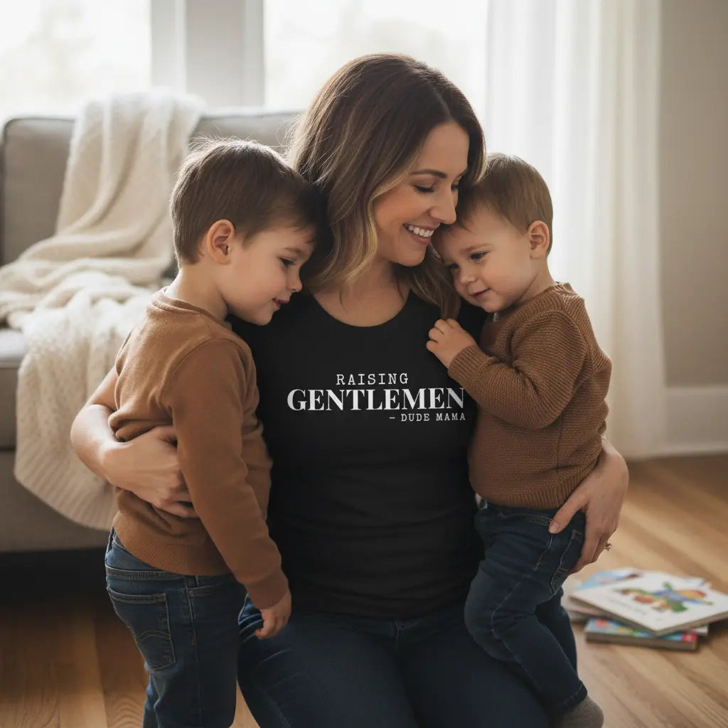 Mom holding her boys wearing a boy mom shirt that says 'Raising Gentlemen'. Dude Mama