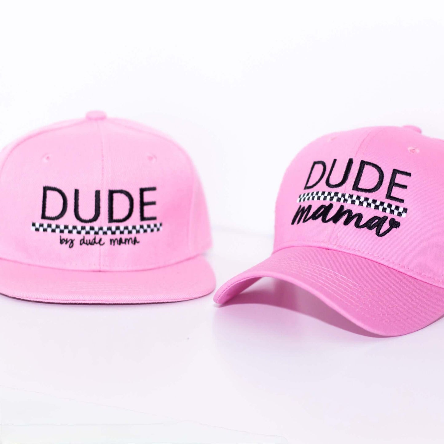 Light pink matching mom and son hats. The boys hat says 'Dude' and the mama hat says 'Dude Mama'. featuring 'Dude' and 'Dude Mama' designs.